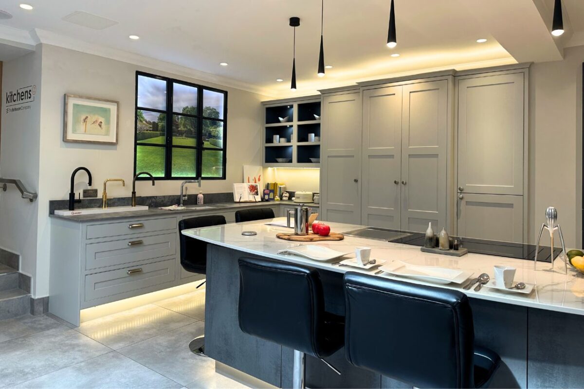 A large kitchen island on display in our Perth showroom, with bespoke cabinetry with integrated appliances