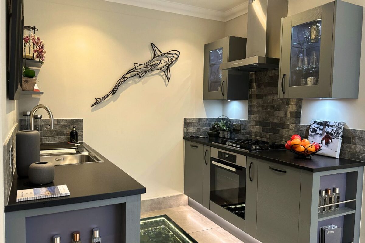 Bespoke kitchen cabinetery with hob and oven, with stone top countertop.