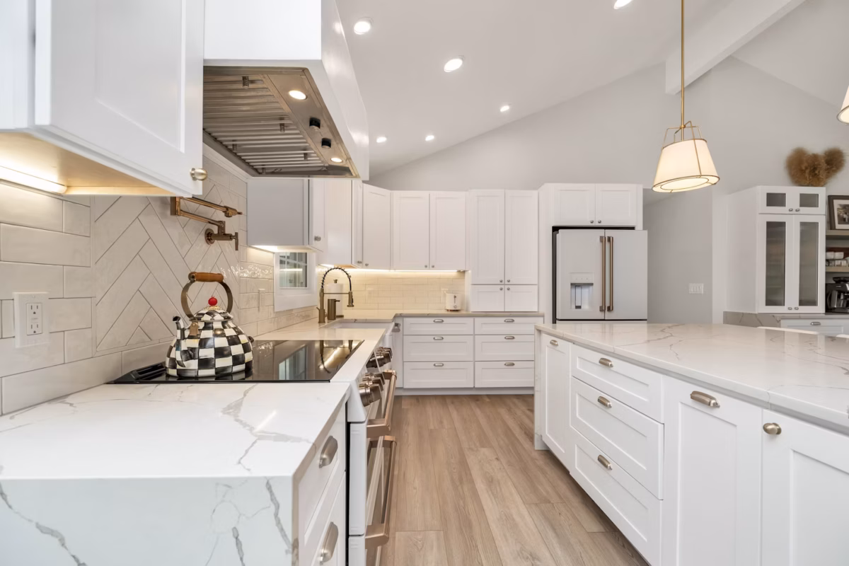 A shaker-style kitchen in a white finish, featuring beautifully fitted cabinetry that enhances the flow of a spacious kitchen layout.