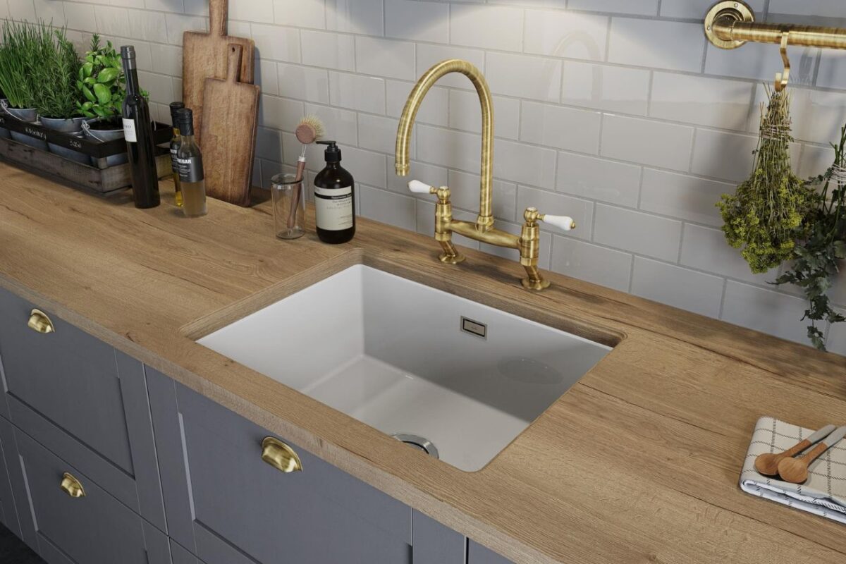 An Abode sink and tap seamlessly integrated into the kitchen countertop, combining style with premium functionality.